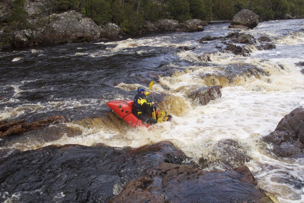 Picture of packraft running a rapid