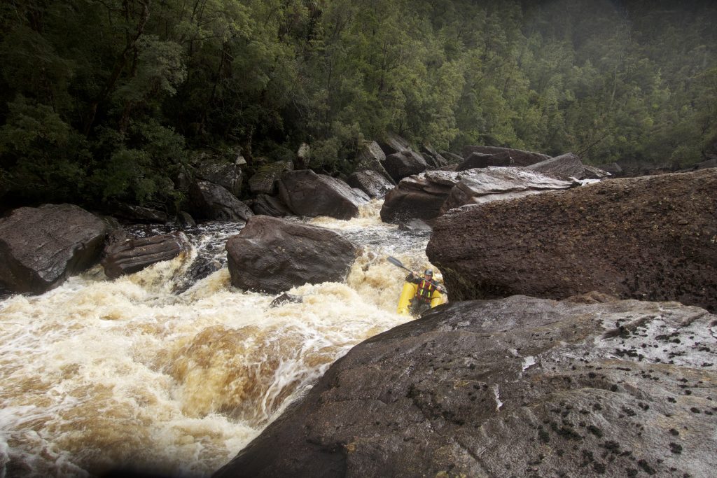 Picture of packraft nose diving in to a large rapid