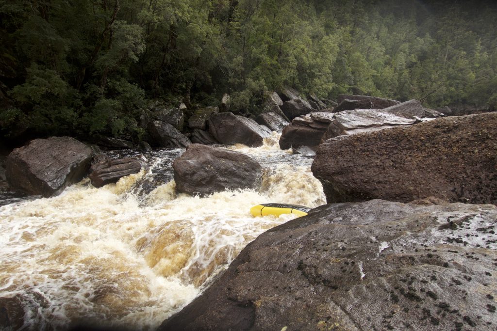 Picture of upturned packraft in the river